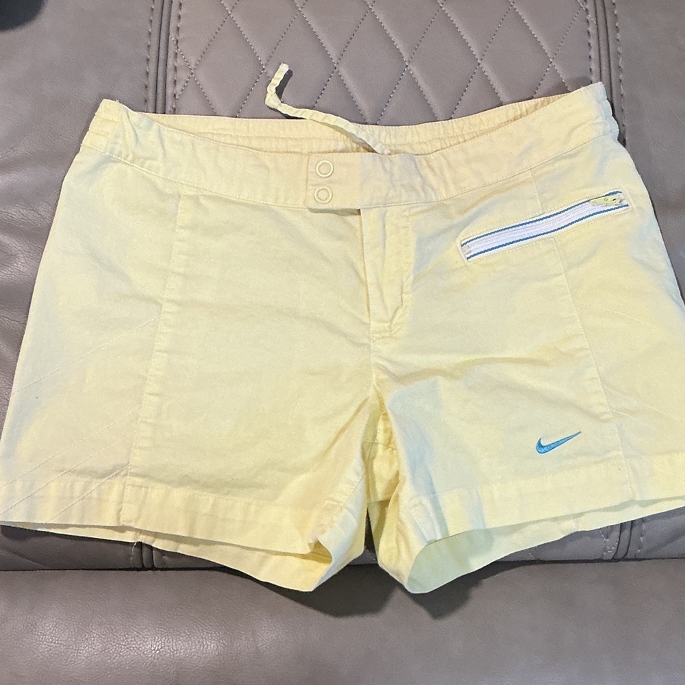 Nike Women's Pale Yellow Athletic Shorts with Blue Logo